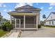 Rear view of home showing screened porch with solar panels on the roof at 4140 Home Town Ln, Ravenel, SC 29470
