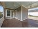 Relaxing screened porch with ceiling fans and stained wood flooring at 4140 Home Town Ln, Ravenel, SC 29470