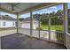 View from a screened porch with stained wood flooring and view of garage at 4140 Home Town Ln, Ravenel, SC 29470