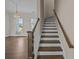 A staircase with a wooden railing with a view to the living room at 4140 Home Town Ln, Ravenel, SC 29470