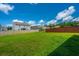 Spacious backyard with lush green grass and a wood privacy fence on a sunny day at 431 Buckhannon Ln, Moncks Corner, SC 29461