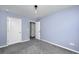Cozy bedroom with light blue walls, neutral carpet, and white trim throughout at 431 Buckhannon Ln, Moncks Corner, SC 29461