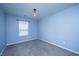 Empty bedroom with light blue walls, neutral carpet, and a single window providing natural light at 431 Buckhannon Ln, Moncks Corner, SC 29461