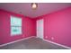 Bedroom featuring bright pink walls, plush carpeting, a window, and a closet at 431 Buckhannon Ln, Moncks Corner, SC 29461