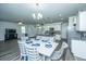 Bright dining area with a modern table set and an open view to the kitchen and living spaces at 431 Buckhannon Ln, Moncks Corner, SC 29461