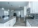 Well-equipped kitchen with stainless steel appliances, granite countertops, and an open view to the living room at 431 Buckhannon Ln, Moncks Corner, SC 29461