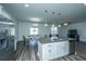 Modern kitchen island boasts granite countertops, stainless appliances, and an open concept into the dining and living areas at 431 Buckhannon Ln, Moncks Corner, SC 29461