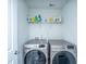 Laundry room featuring modern washer and dryer units, and a shelf for storage of supplies at 431 Buckhannon Ln, Moncks Corner, SC 29461
