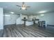 Spacious living room with modern flooring, a ceiling fan, and an open concept to the kitchen at 431 Buckhannon Ln, Moncks Corner, SC 29461