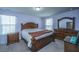 Cozy bedroom featuring a plush carpet, complemented by a wooden bedroom set and a brown throw blanket at 431 Buckhannon Ln, Moncks Corner, SC 29461