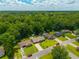 An aerial view of well-maintained suburban homes surrounded by green trees on a sunny day with blue sky at 439 Temple Rd, Ladson, SC 29456