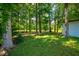 Green backyard with beautiful tall trees with a storage shed for lawn equipment at 439 Temple Rd, Ladson, SC 29456