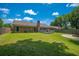 Brick home's spacious, grassy backyard has a stone fire pit, patio, and wood deck at 439 Temple Rd, Ladson, SC 29456