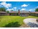 Beautiful backyard with green lawn and brick house with deck and round stone patio at 439 Temple Rd, Ladson, SC 29456