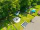 An aerial view of a backyard with a fire pit, storage shed, toys and a trampoline at 439 Temple Rd, Ladson, SC 29456