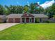Charming single-story home with a well-maintained lawn, attached garage, and beautiful landscaping at 439 Temple Rd, Ladson, SC 29456