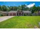 Inviting single-Gathering home with an attached garage and lush, green front yard on a sunny day at 439 Temple Rd, Ladson, SC 29456