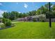 Charming single-story home with a well-kept lawn, stone flower bed, and mature trees at 439 Temple Rd, Ladson, SC 29456