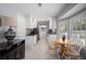 Eat-in kitchen features tile floors, sleek counters, stainless sink, and modern finishes at 439 Temple Rd, Ladson, SC 29456