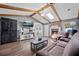Bright living room boasts a fireplace, wood beams, hardwood floors, and TV at 439 Temple Rd, Ladson, SC 29456