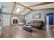 Comfortable living room with hardwood floors, wood beam ceiling, stone fireplace, and natural light at 439 Temple Rd, Ladson, SC 29456