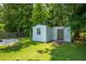 A storage shed with a window and wood door in the backyard offers convenient storage solutions at 439 Temple Rd, Ladson, SC 29456