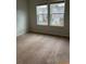 Bright bedroom with plush carpeting, large windows, and neutral walls, offering a serene retreat at 4669 Palm View Cir, North Charleston, SC 29418