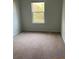 Cozy bedroom with soft carpeting and a bright window offering natural light at 4669 Palm View Cir, North Charleston, SC 29418