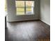 Bright living space with modern flooring and a large window with natural views at 4669 Palm View Cir, North Charleston, SC 29418