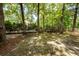 Shady backyard with mature trees, a hammock, and a wooden fence at 477 Commonwealth Rd, Mount Pleasant, SC 29466