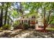 Secluded backyard featuring a patio and screened-in porch, surrounded by mature trees at 477 Commonwealth Rd, Mount Pleasant, SC 29466