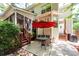 Cozy backyard patio with an outdoor table, chairs, and lush greenery at 477 Commonwealth Rd, Mount Pleasant, SC 29466