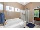 A luxurious soaking tub and glass enclosed shower in a Primary bath at 477 Commonwealth Rd, Mount Pleasant, SC 29466