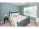 Cozy bedroom featuring a queen-size bed and a window that fills the room with natural light at 477 Commonwealth Rd, Mount Pleasant, SC 29466