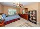 Comfortable bedroom features a ceiling fan, window with blinds, and a dresser with a mirror at 477 Commonwealth Rd, Mount Pleasant, SC 29466