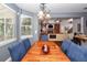 Cozy dining room featuring natural light, wood table, and plush blue chairs, perfect for Gathering gatherings at 477 Commonwealth Rd, Mount Pleasant, SC 29466