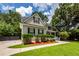 Charming two-story home featuring symmetrical windows, manicured landscaping, and a welcoming front porch at 477 Commonwealth Rd, Mount Pleasant, SC 29466