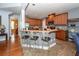 Modern kitchen with stainless steel appliances, eat-in bar, and natural wood cabinets at 477 Commonwealth Rd, Mount Pleasant, SC 29466
