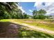 Scenic view of the large lot with a pond and a home nestled among the trees at 477 Commonwealth Rd, Mount Pleasant, SC 29466