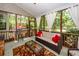 Inviting screened porch featuring comfortable seating and a view of the lush backyard at 477 Commonwealth Rd, Mount Pleasant, SC 29466