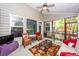 Relaxing sunroom with wicker chairs, a ceiling fan, and view of the outdoor landscape at 477 Commonwealth Rd, Mount Pleasant, SC 29466