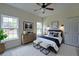 Cozy bedroom with two large windows, a ceiling fan, a dresser, and stylish decor at 480 Longleaf Dr, Walterboro, SC 29488