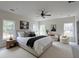Spacious bedroom with natural light, a ceiling fan, a sitting area, and neutral tones at 480 Longleaf Dr, Walterboro, SC 29488