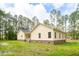 Exterior view of a yellow home, highlighting the new roof and vinyl siding at 480 Longleaf Dr, Walterboro, SC 29488