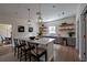 Bright kitchen featuring a large island with seating, open shelving, stainless steel appliances, and modern lighting at 480 Longleaf Dr, Walterboro, SC 29488