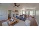 Open-concept living room featuring hardwood floors, a fireplace, a ceiling fan, and a comfortable sofa at 480 Longleaf Dr, Walterboro, SC 29488