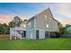 Backyard view featuring a wooden deck and stairs, grassy area, and partial fencing at 492 Sanders Farm Ln, Wando, SC 29492