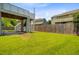 Backyard featuring deck stairs leading to a stone patio and green lawn at 492 Sanders Farm Ln, Wando, SC 29492