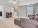 Spacious bonus room featuring a comfortable couch, ceiling fan, and large window offering plenty of natural light at 492 Sanders Farm Ln, Wando, SC 29492