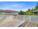 A wide deck with white railings overlooks lush greenery at 492 Sanders Farm Ln, Wando, SC 29492